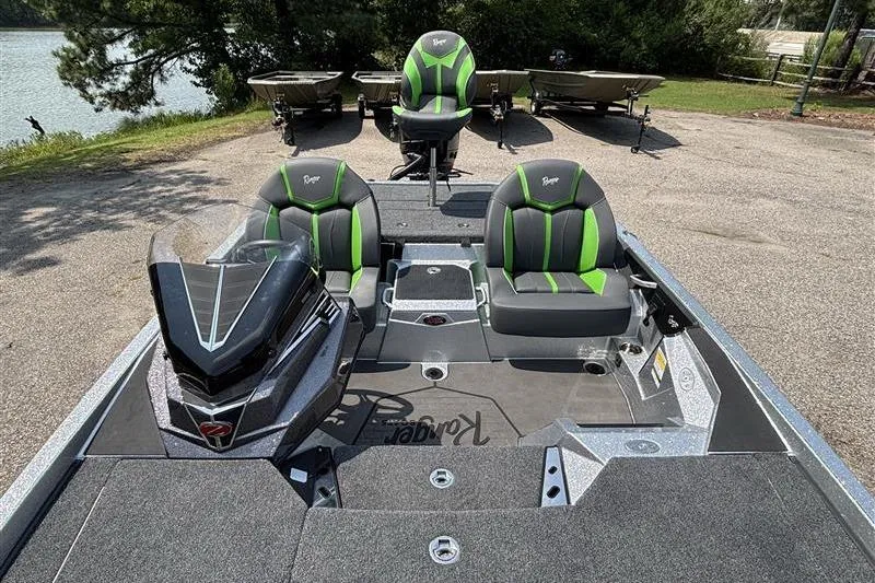 Slide: The Image of 2026 Ranger Z519R Cup-Equipped boat with green-accented seats, parked near a lake. - 20