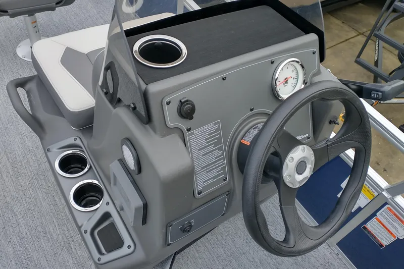 Slide: The Image of 2026 Sun Tracker Bass Buggy 16 XL Select steering console with cup holders and RPM gauge. - 8