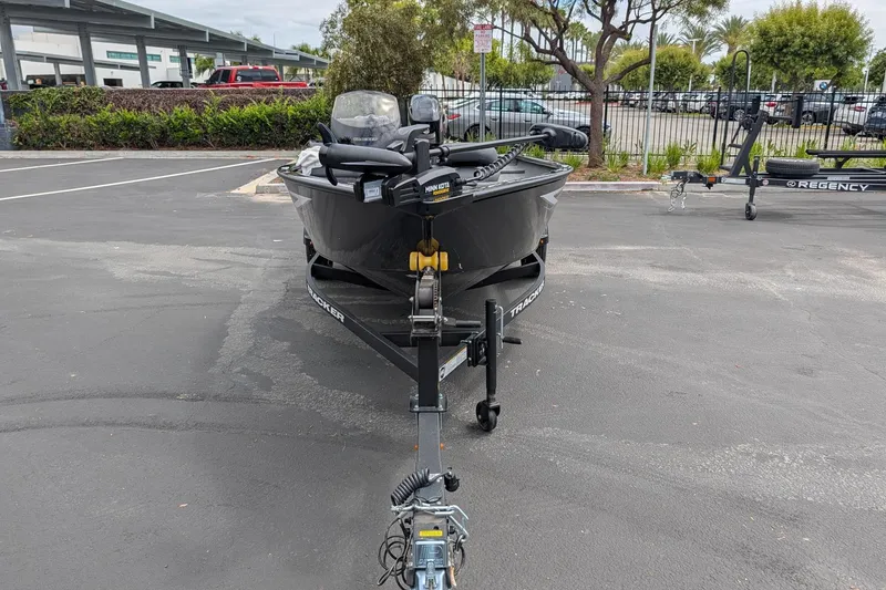 Slide: The Image of 2026 Tracker Super Guide V-16 SC boat on trailer in parking lot. - 2