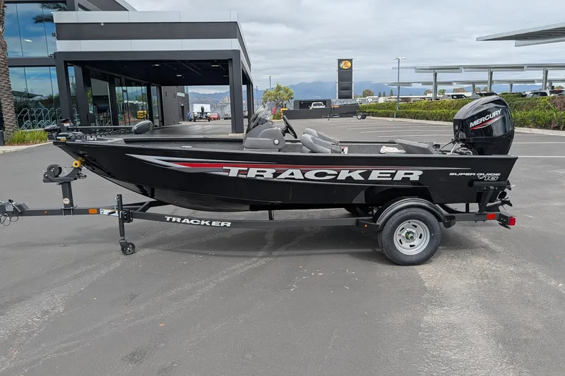 Slide: The Image of 2026 Tracker Super Guide V-16 SC boat on trailer in parking lot. - 4