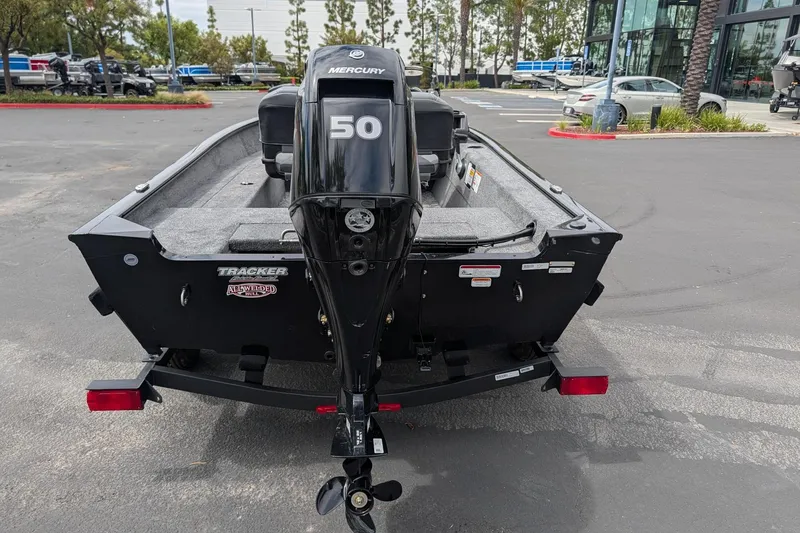 Slide: The Image of 2026 Tracker Super Guide V-16 SC boat with Mercury 50 engine in parking lot. - 5