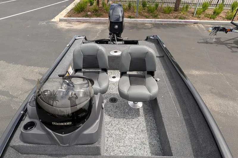 Slide: The Image of 2026 Tracker Super Guide V-16 SC boat interior with dual seats and steering console. - 6