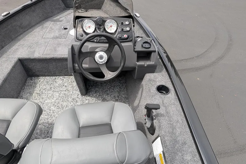Slide: The Image of 2026 Tracker Super Guide V-16 SC boat interior with steering wheel and dashboard controls. - 8