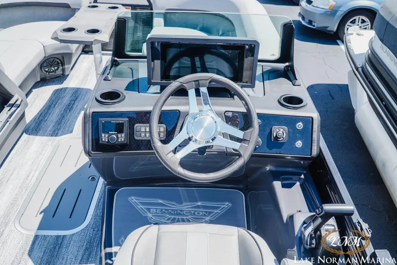 Slide: The Image of 2026 Bennington 23MSB boat dashboard with steering wheel and control panel at Lake Norman Marina. - 10
