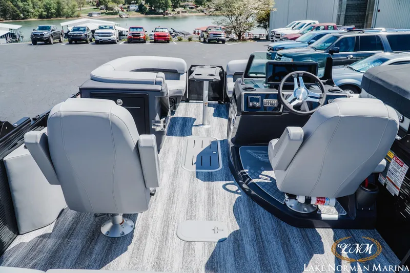 Slide: The Image of 2026 Bennington 23MSB pontoon boat interior with modern seating and steering console. - 7