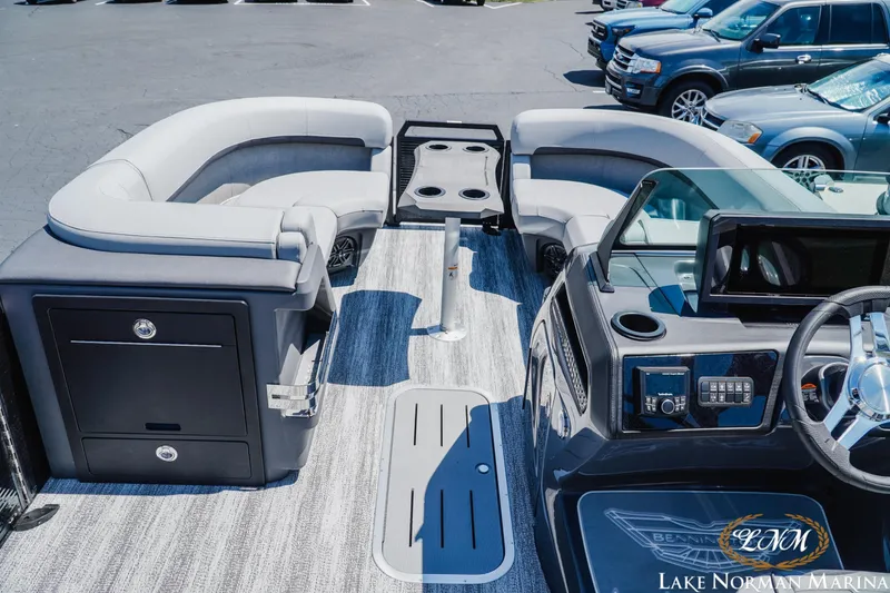 Slide: The Image of 2026 Bennington 23MSB pontoon boat interior with plush seating and modern dashboard at Lake Norman Marina. - 8