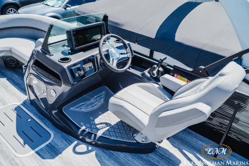 Slide: The Image of 2026 Bennington 23MSB boat helm with modern controls and comfortable seating at Lake Norman Marina. - 9