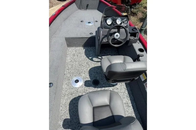 Slide: The Image of 2026 Tracker Super Guide V-16 SC boat interior with steering console and seating. - 7