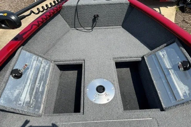 Slide: The Image of 2026 Tracker Super Guide V-16 SC boat interior with storage compartments and carpeted flooring. - 9
