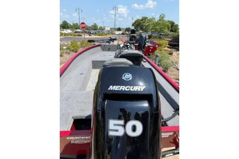 Slide: The Image of 2026 Tracker Super Guide V-16 SC boat with Mercury 50 engine, parked outdoors. - 4