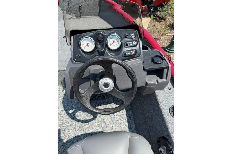 Slide: The Image of Steering console of 2026 Tracker Super Guide V-16 SC boat with gauges and controls. - 5