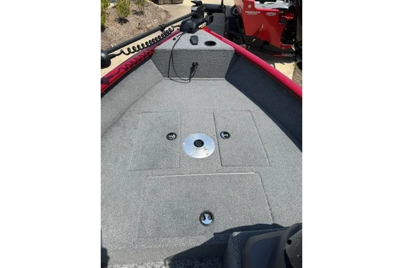 Slide: The Image of 2026 Tracker Super Guide V-16 SC boat interior with carpeted deck and storage compartments. - 8
