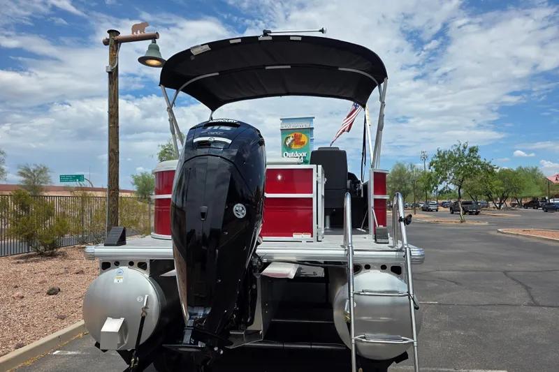 Slide: The Image of 2026 Sun Tracker Party Barge 20 DLX pontoon boat with Mercury outboard motor in parking lot. - 3