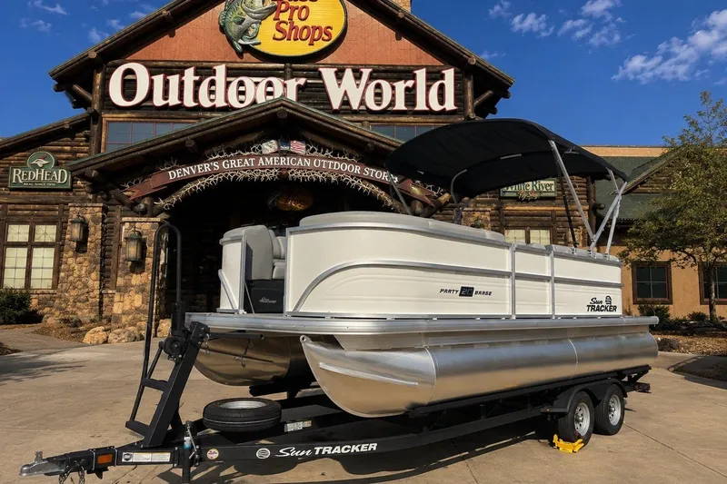 The Image of 2026 Sun Tracker Party Barge 20 DLX pontoon boat outside Outdoor World store. - 0