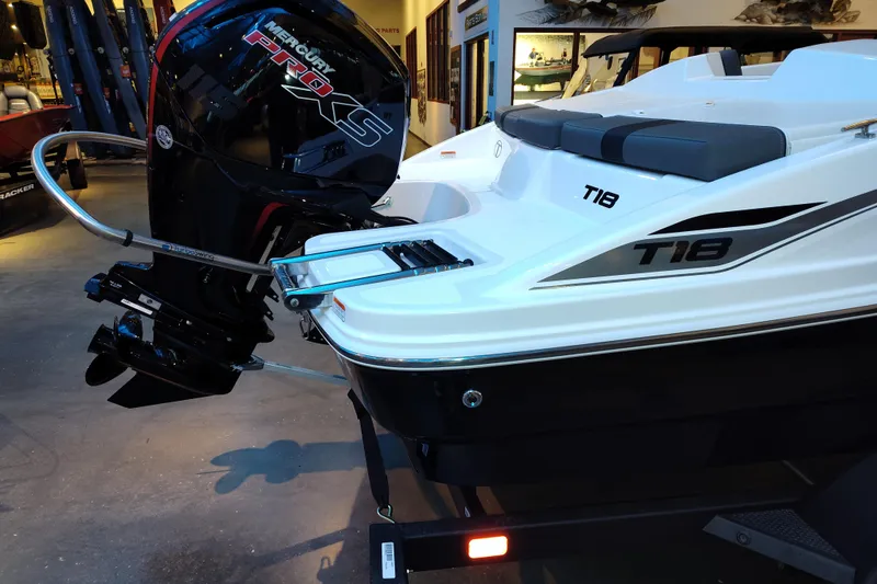 Slide: The Image of 2026 Tahoe T18 boat with Mercury Pro XS engine, displayed indoors. - 1