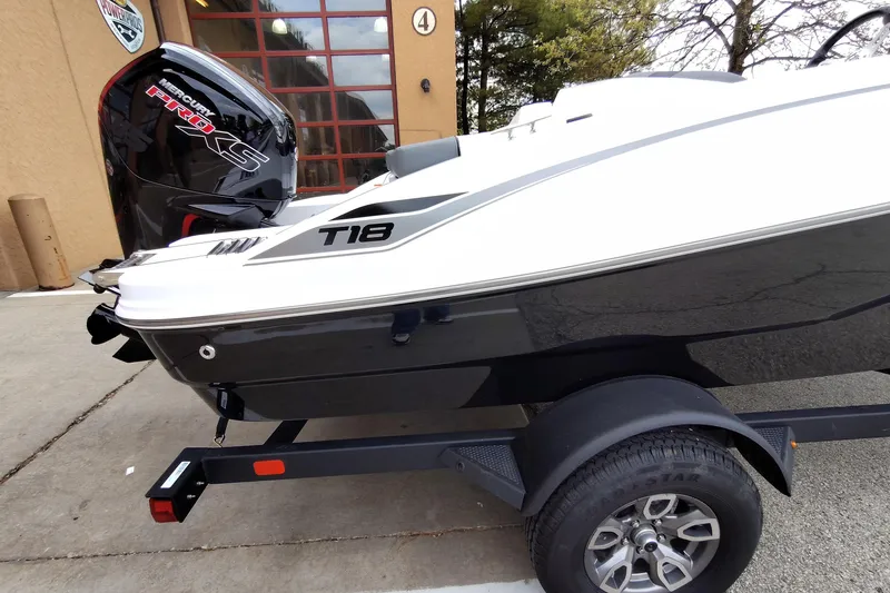 Slide: The Image of 2026 Tahoe T18 boat on trailer with Mercury Pro XS engine, parked outdoors. - 2