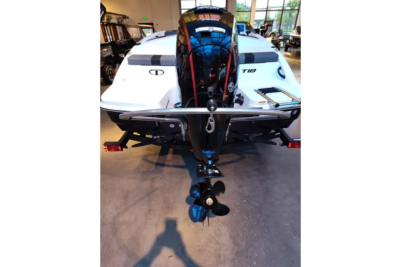 Slide: The Image of 2026 Tahoe T18 boat with Mercury outboard motor, displayed indoors. - 8