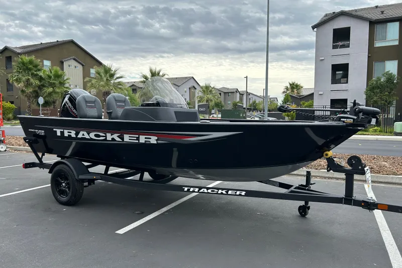 Slide: The Image of 2026 Tracker Pro Guide V-16 SC boat on trailer in parking lot. - 3