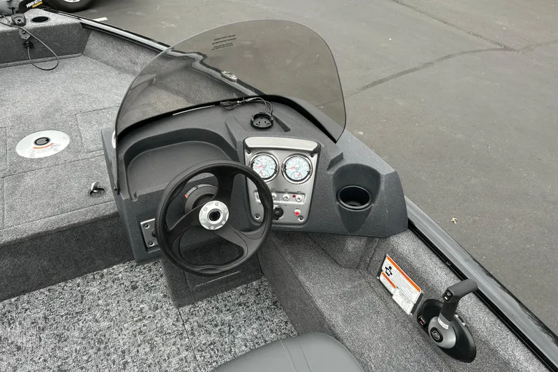 Slide: The Image of 2026 Tracker Pro Guide V-16 SC boat dashboard with steering wheel and gauges. - 14