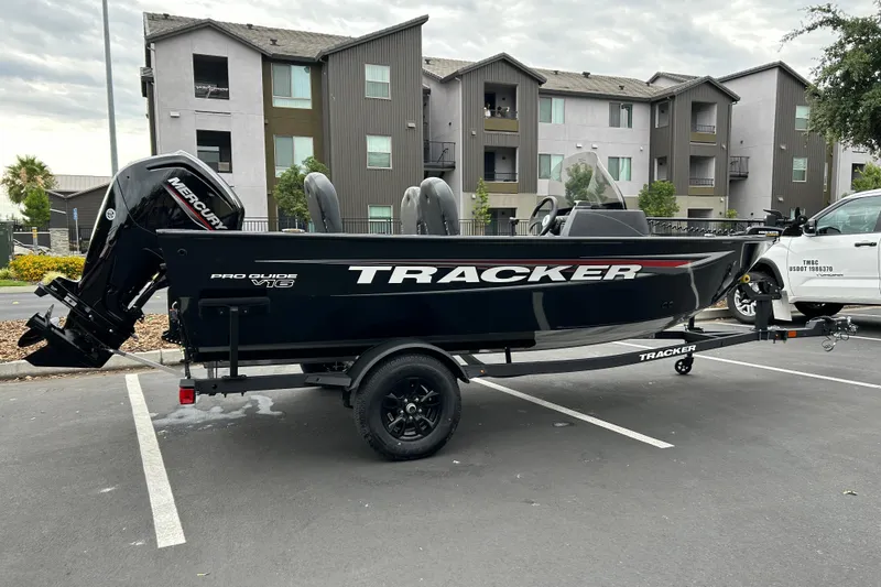 Slide: The Image of 2026 Tracker Pro Guide V-16 SC boat on trailer in parking lot. - 2