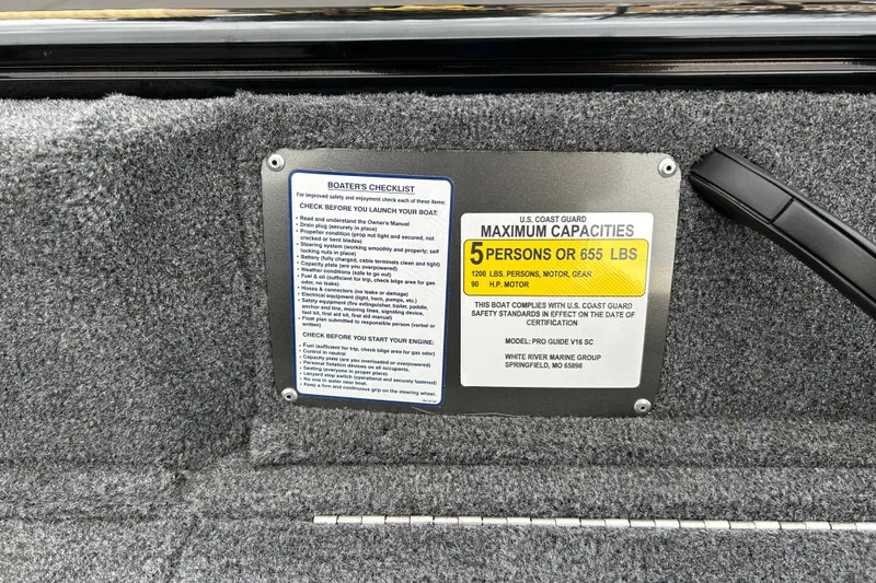 Slide: The Image of Boater's checklist and capacity label on 2026 Tracker Pro Guide V-16 SC boat. - 13