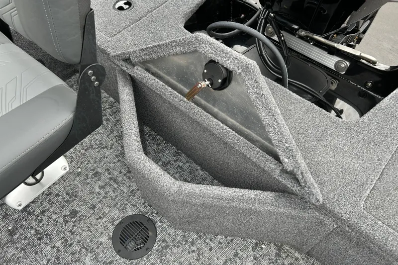 Slide: The Image of 2026 Tracker Pro Guide V-16 SC boat interior with gray seating and carpeted flooring. - 9
