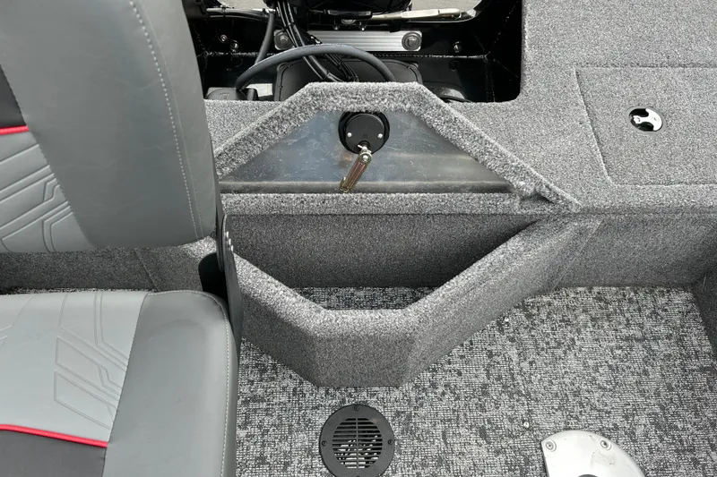 Slide: The Image of Interior view of 2026 Tracker Pro Guide V-16 SC boat, featuring seating and carpeted flooring. - 8