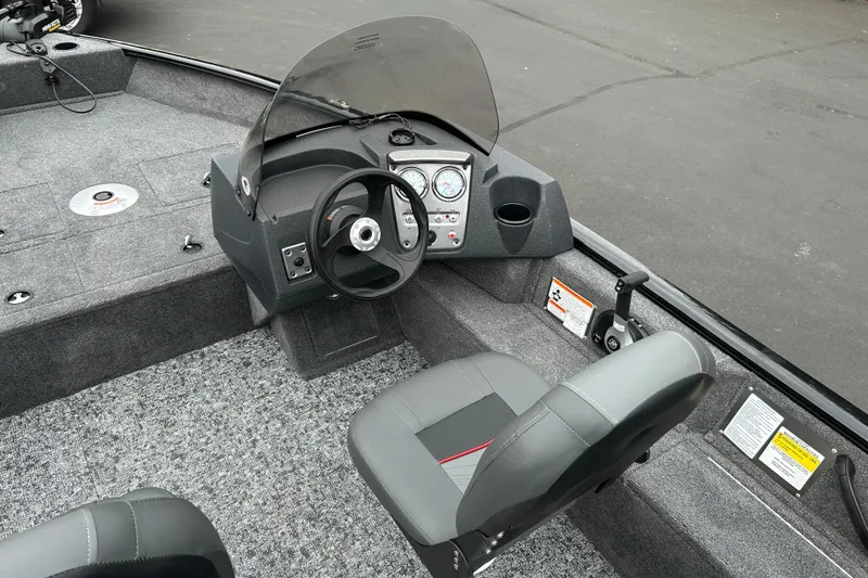 Slide: The Image of 2026 Tracker Pro Guide V-16 SC boat interior with steering console and seating. - 15