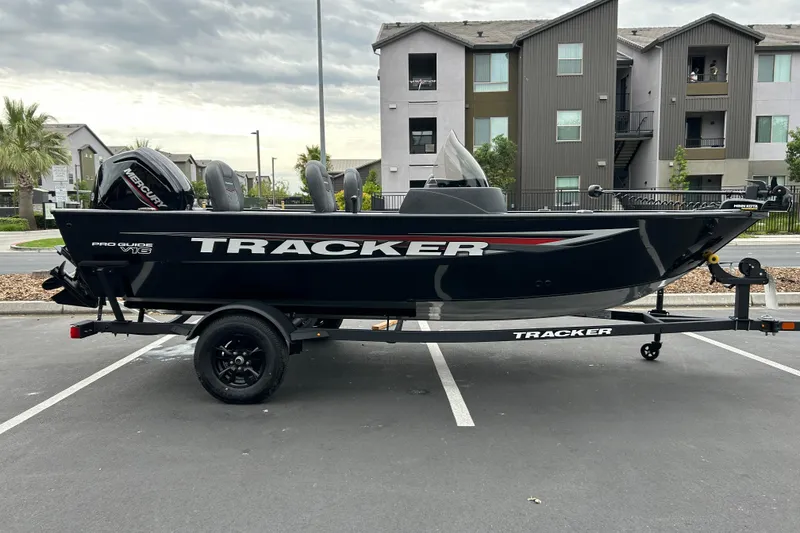 The Image of 2026 Tracker Pro Guide V-16 SC boat parked in a residential area. - 0