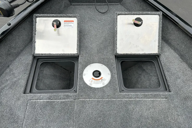 Slide: The Image of 2026 Tracker Pro Guide V-16 SC boat storage compartments with open hatches. - 18