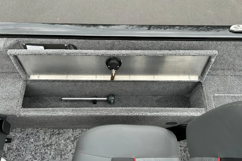 Slide: The Image of 2026 Tracker Pro Guide V-16 SC boat storage compartment with gray interior and seating. - 10