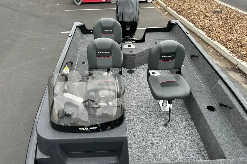 Slide: The Image of 2026 Tracker Pro Guide V-16 SC boat interior with seating and steering console. - 23