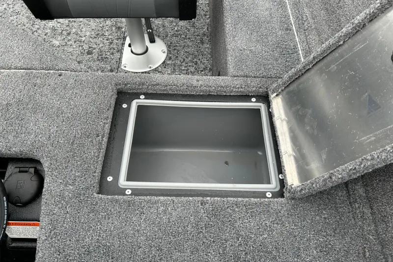 Slide: The Image of Open storage compartment in 2026 Tracker Pro Guide V-16 SC boat interior. - 7