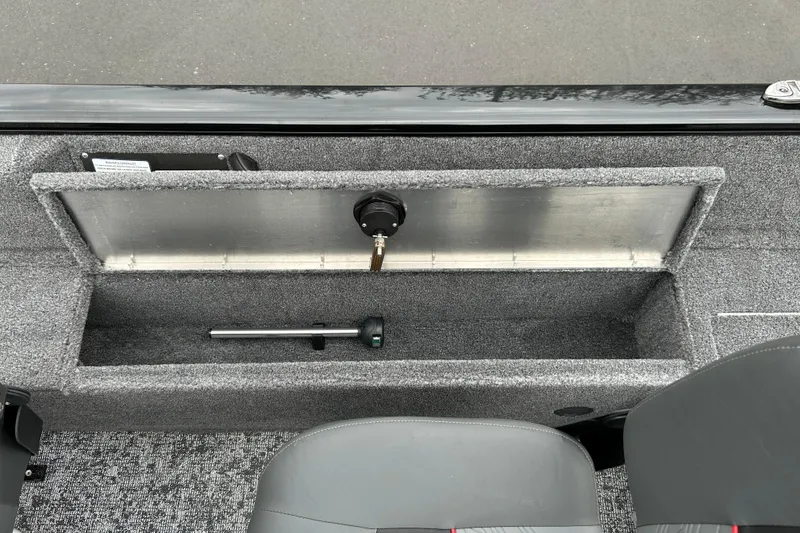 Slide: The Image of 2026 Tracker Pro Guide V-16 SC boat storage compartment with gray interior and seating. - 11