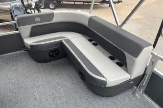 Slide: The Image of 2026 Sun Tracker Bass Buggy 16 XL Select pontoon boat seating, featuring gray and black upholstery. - 16