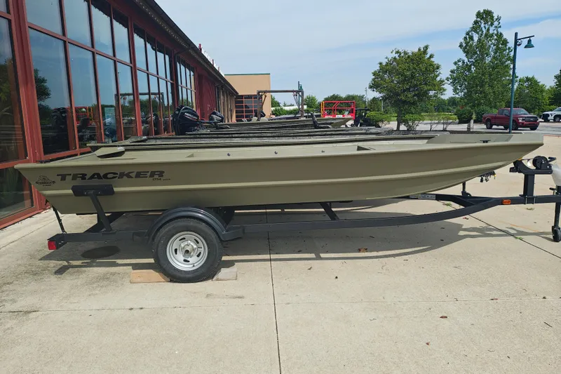 The Image of 2026 Tracker Grizzly 1754 Utility boat on trailer, parked outdoors. - 17