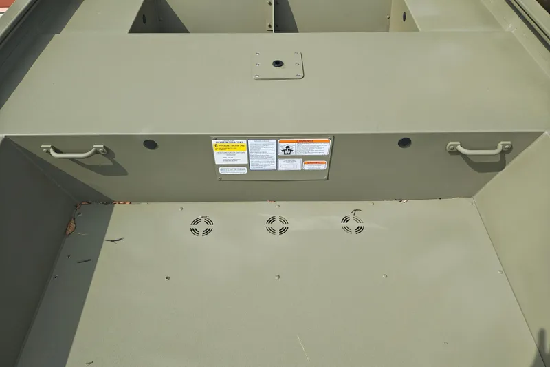 Slide: The Image of Interior view of 2026 Tracker Grizzly 1754 Utility boat, featuring handles and warning labels. - 23