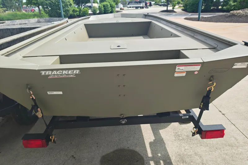 Slide: The Image of 2026 Tracker Grizzly 1754 Utility boat on trailer, parked outdoors. - 19