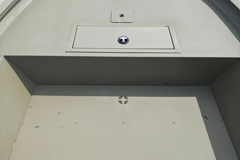 Slide: The Image of 2026 Tracker Grizzly 1754 Utility boat interior with storage compartment and clean deck. - 22
