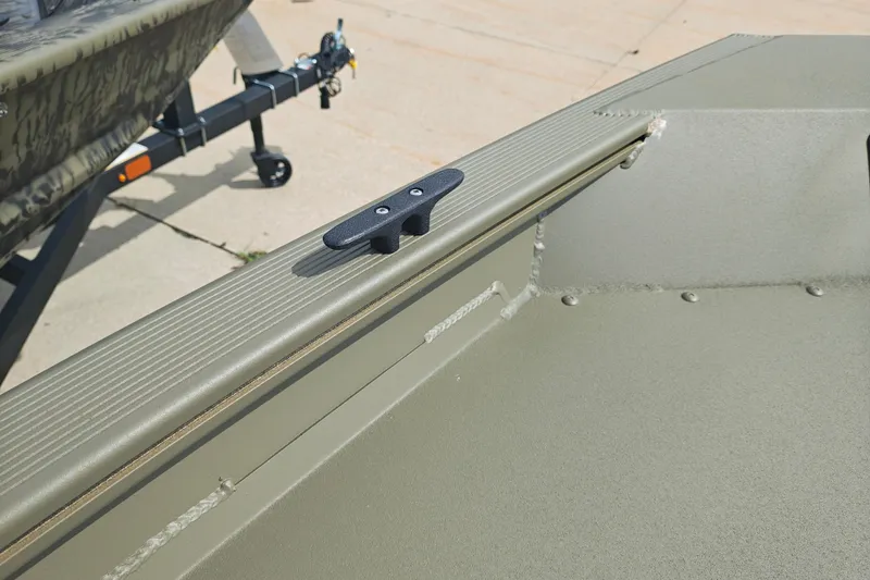 Slide: The Image of 2026 Tracker Grizzly 1754 Utility boat detail, featuring a cleat on the deck. - 26