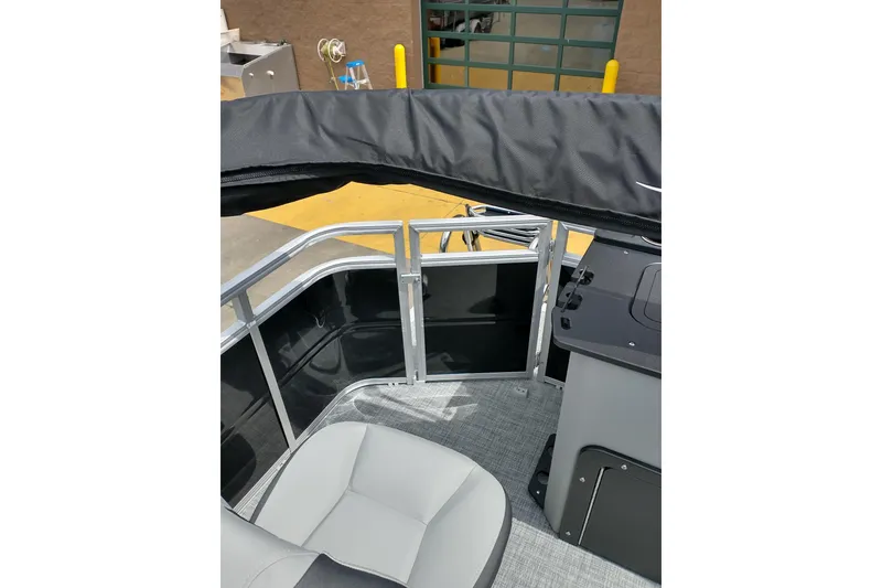 Slide: The Image of 2026 Sun Tracker Fishin' Barge 20 DLX interior with seating and railing details. - 16