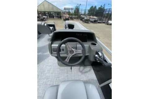 Slide: The Image of 2026 Sun Tracker Fishin' Barge 20 DLX steering console with modern controls and seating. - 18