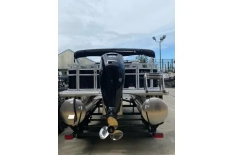Slide: The Image of 2026 Sun Tracker Fishin' Barge 20 DLX pontoon boat, rear view with motor and pontoons. - 19