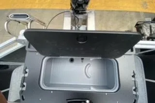 Slide: The Image of 2026 Sun Tracker Fishin' Barge 20 DLX livewell, open lid, showcasing interior features. - 21