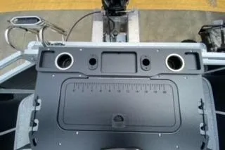 Slide: The Image of 2026 Sun Tracker Fishin' Barge 20 DLX boat console with cup holders and storage. - 22
