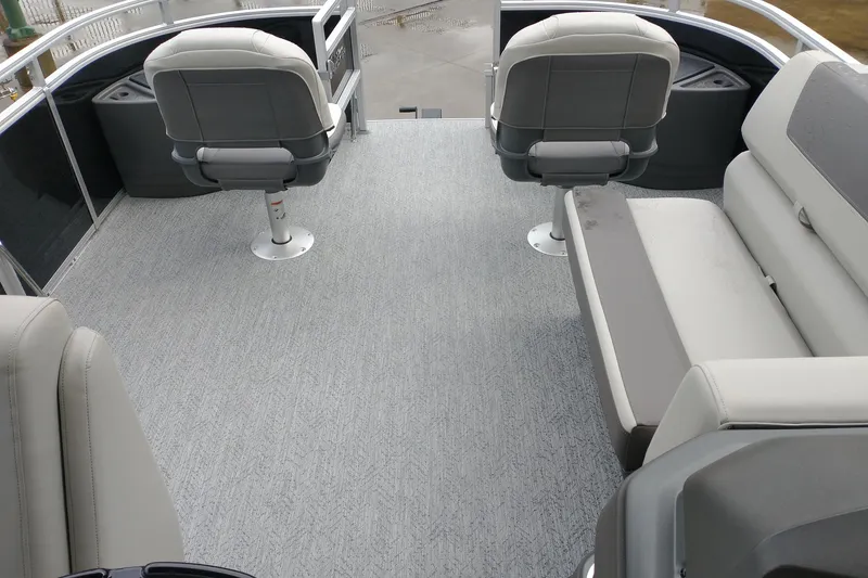 Slide: The Image of 2026 Sun Tracker Fishin' Barge 20 DLX interior with gray seating and flooring. - 7