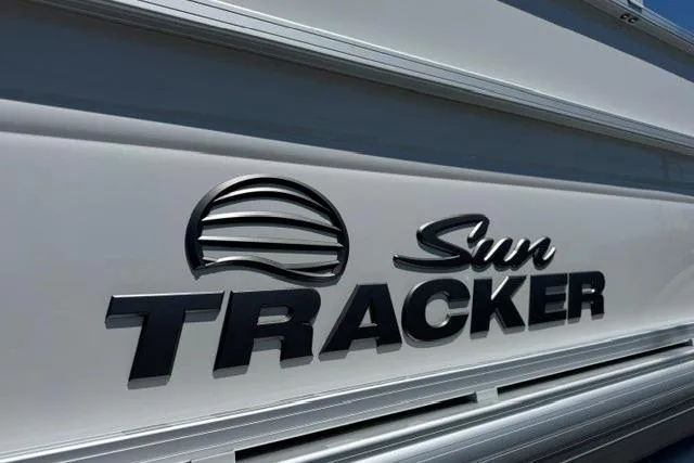 Slide: The Image of 2026 Sun Tracker Party Barge 20 DLX logo on sleek boat exterior. - 19