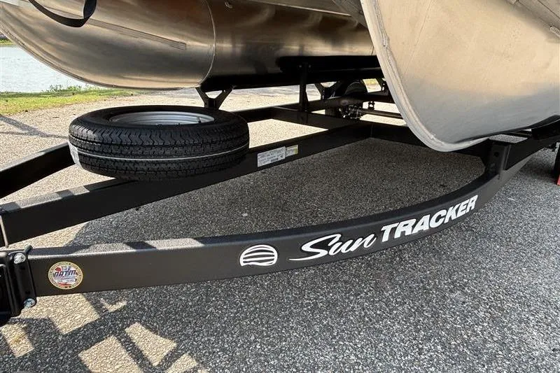 Slide: The Image of Trailer of 2026 Sun Tracker Party Barge 16 DLX with spare tire on pavement. - 5