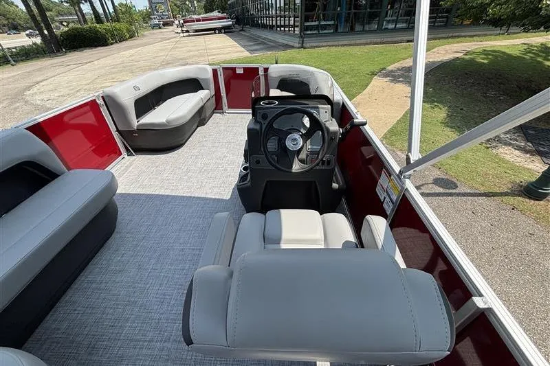 Slide: The Image of 2026 Sun Tracker Party Barge 16 DLX interior with seating and steering console. - 13