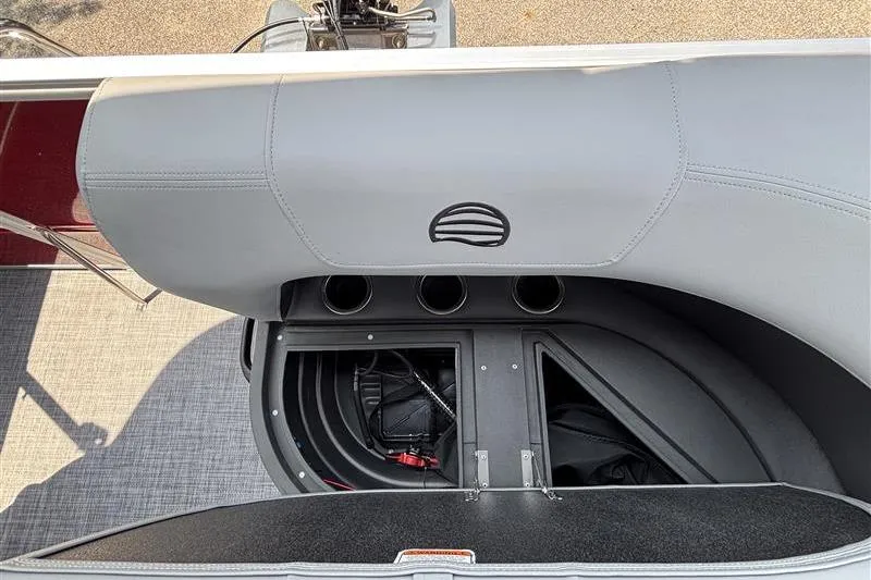Slide: The Image of 2026 Sun Tracker Party Barge 16 DLX storage compartment with seating and cup holders. - 18